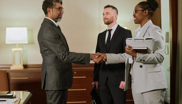 businesswoman-shaking-hand-of-partner-2025-03-15-13-43-17-utc